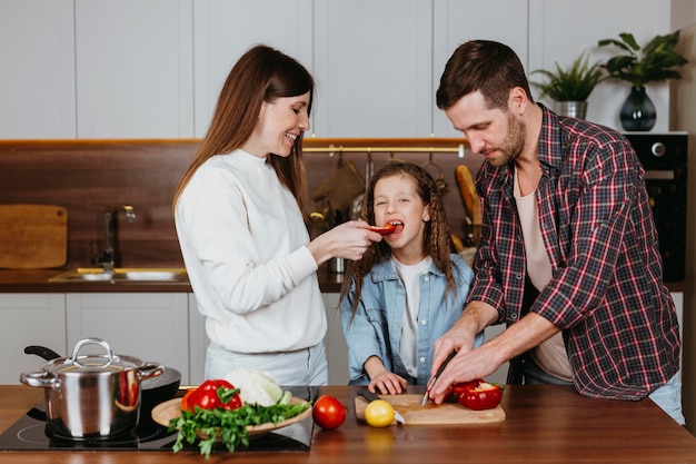 Front view of family preparing food at home