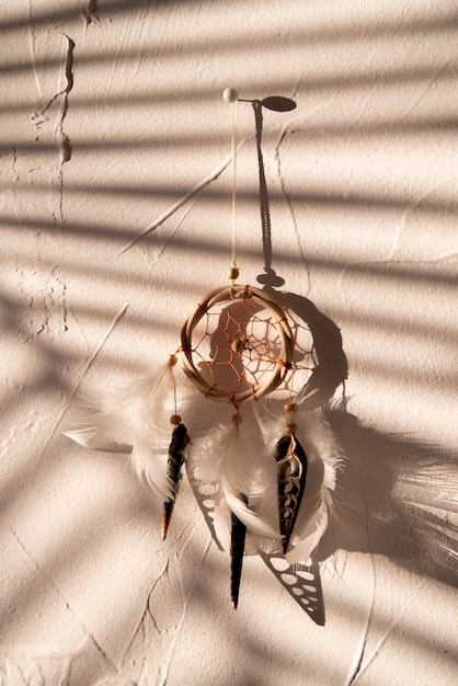 Free photo front view of feathered dreamcatcher in the shadows