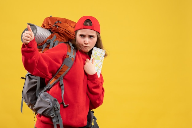 Free Photo front view female backpacker holding travel map giving thumbs up