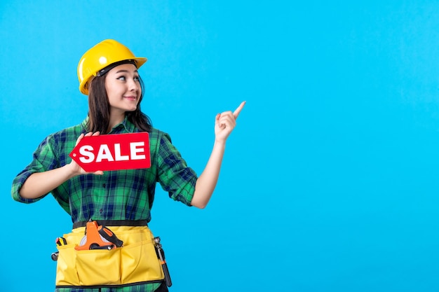 Free Photo front view female builder holding red sale writing on a blue