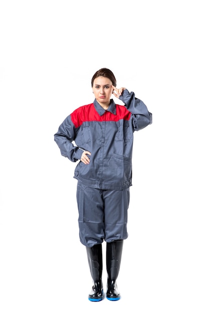 Free photo front view of female builder in uniform on white wall