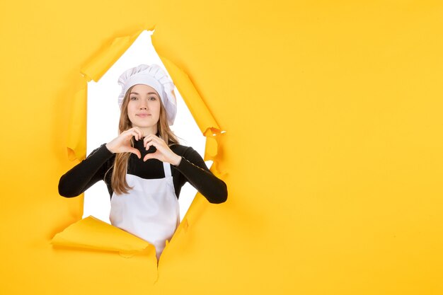 Front view female cook sending love on yellow food sun emotion color cuisine photo paper job