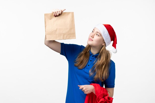 Front view of female courier with food delivery on white wall