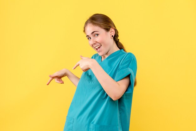 Front view female doctor excited on yellow background medic health hospital virus