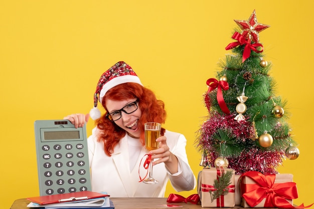 Free photo front view female doctor holding calculator and champagne