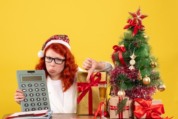 Front view female doctor holding calculator