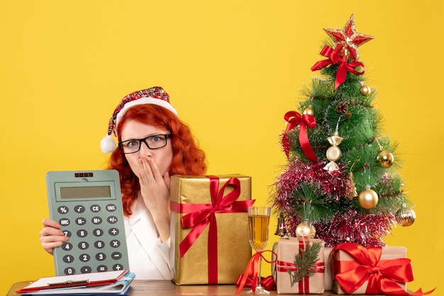 Front view female doctor holding calculator