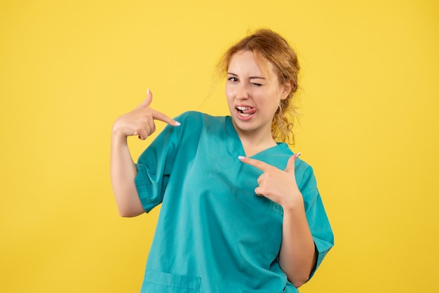 Free photo front view female doctor in medical shirt, color health covid-19 medic nurse