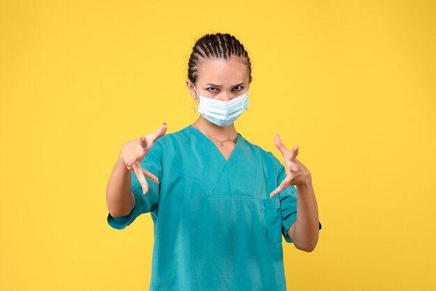 Front view female doctor in medical shirt and mask, health nurse hospital virus covid-19 pandemic color