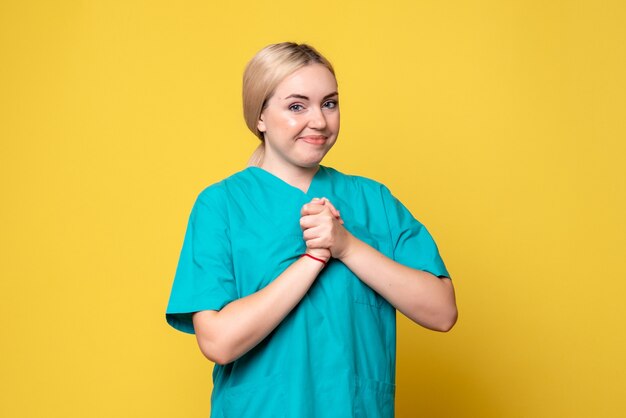 Front view female doctor in medical shirt, pandemic covid nurse medic emotion