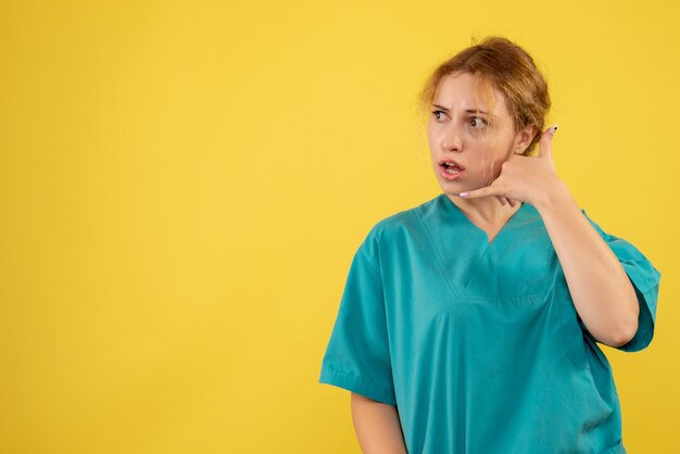 Front view female doctor in medical shirt posing, color hospital nurse covid health medic