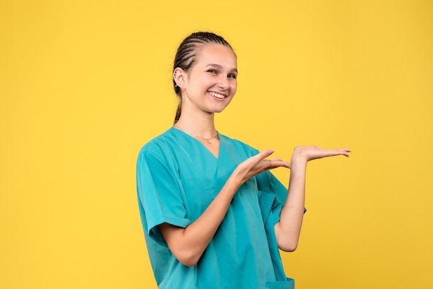 Front view female doctor in medical shirt smiling, virus health emotion covid color nurse hospital