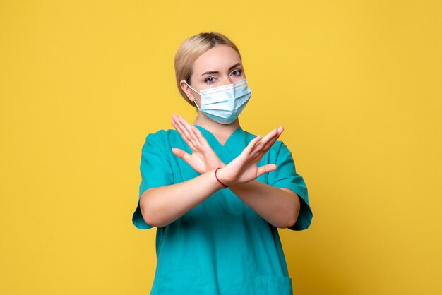 Front view female doctor in medical shirt and sterile mask, hospital nurse health pandemic medic