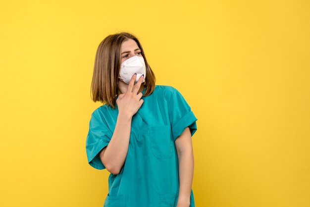 Front view female doctor posing on yellow space