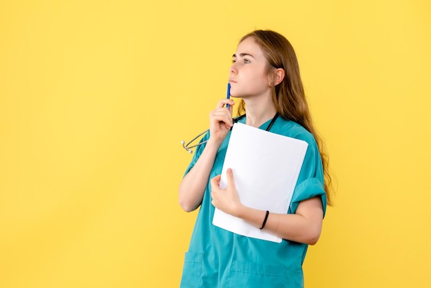 Front view of female doctor with medical papers