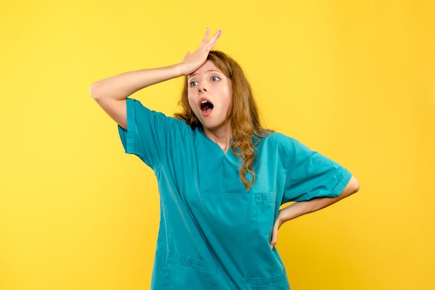 Free Photo front view of female doctor on yellow wall