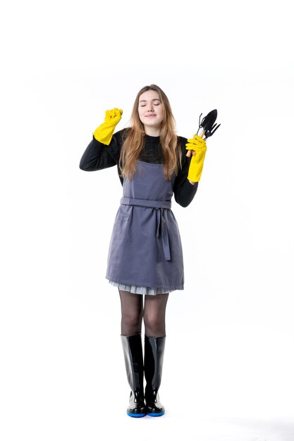 Front view female gardener in yellow gloves on white