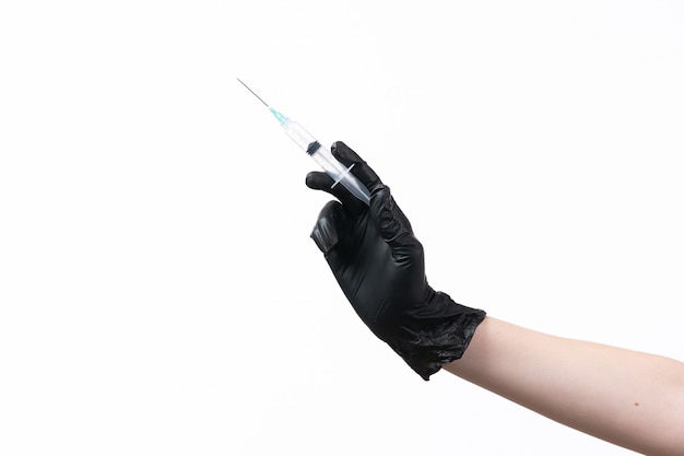 A front view female hand in black glove holding injection on white