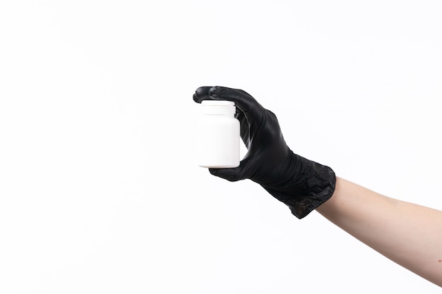 A front view female hand holding white tube in black gloves on white