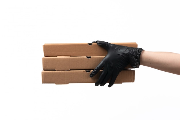 A front view female hands in black gloves holding delivery boxes on white