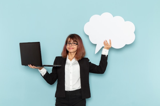 Free Photo front view female office worker holding white sign and laptop on the blue surface