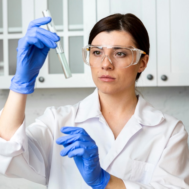 Free photo front view of female researcher with test tube