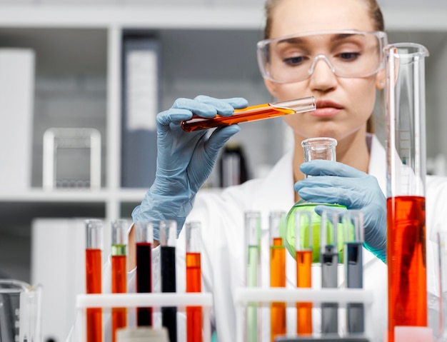 Free photo front view of female researcher with test tubes