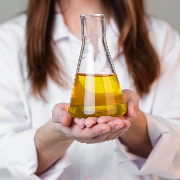 Free photo front view of female scientist holding test tube