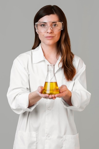 Free Photo front view of female scientist with safety glasses and test tube