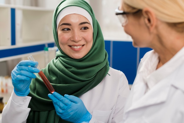 Front view of female scientists in the lab analyzing substance