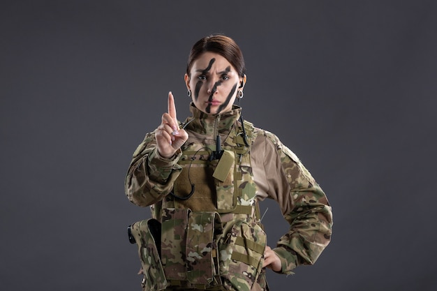 Free Photo front view of female soldier in military uniform on dark wall