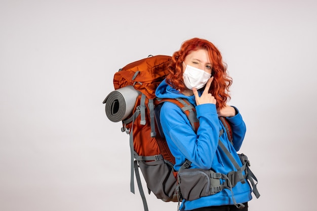 Front view female tourist going in mountain trip with backpack