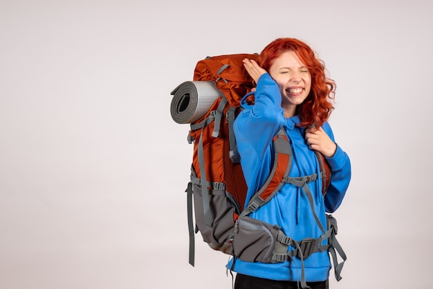 Front view female tourist going in mountain trip with backpack