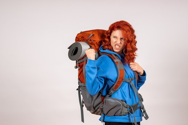 Front view female tourist going in mountain trip with backpack