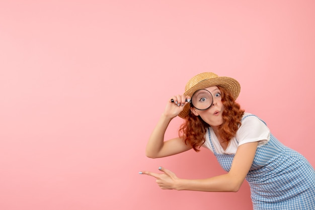 Free photo front view female tourist holding magnifier