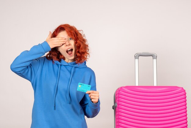 Front view female tourist with bank card and pink bag