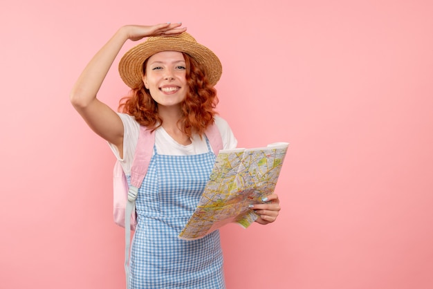 Front view female tourist with map trying to find direction in foreign country