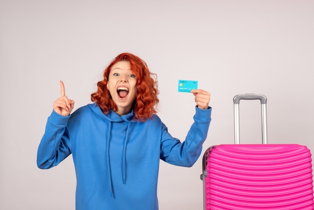 Free Photo front view female tourist with pink bag and holding bank card