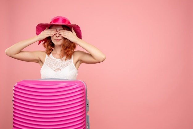 Free Photo front view of female tourist with pink bag on pink wall