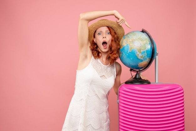 Free Photo front view of female tourist with pink bag on pink wall