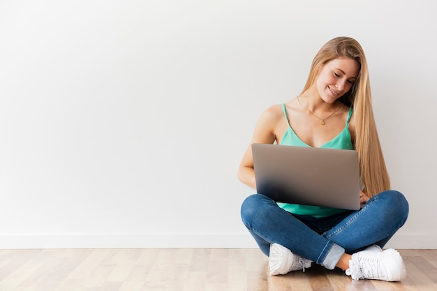 Front view female working on laptop with copy space