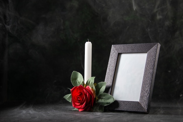 Front view of fireless candle with picture frame on black