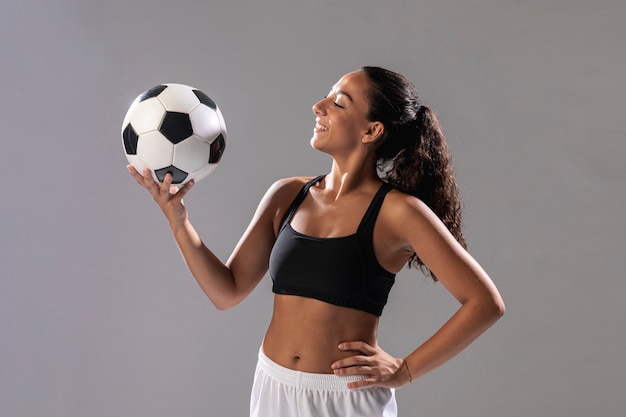 Free photo front view fit woman holding ball