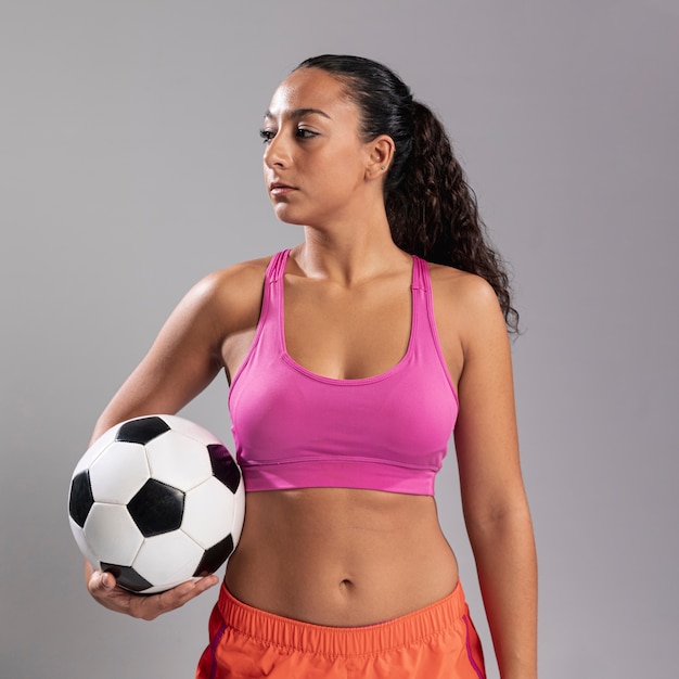 Free photo front view fit woman holding ball