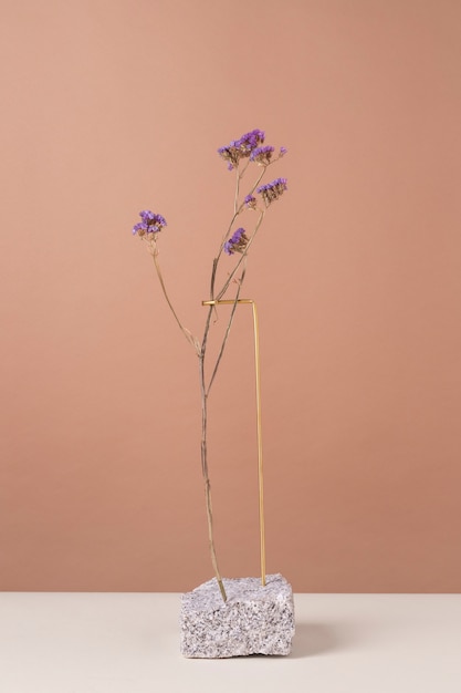 Free photo front view of flower decor on a rock stand