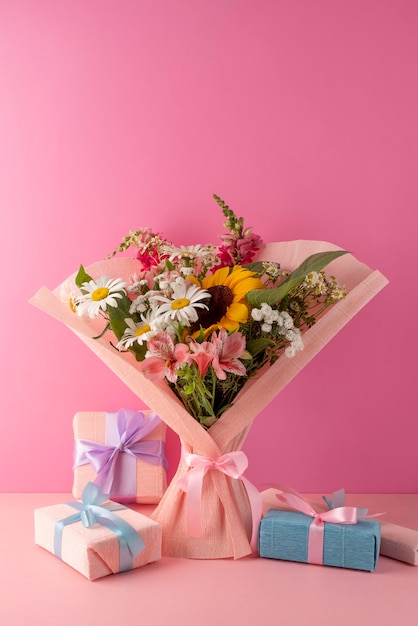 Front view of flowers bouquet with presents