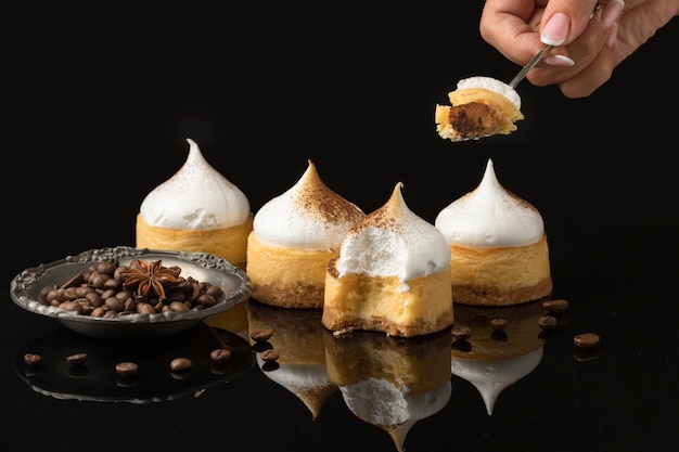 Free photo front view of four desserts with powdered cocoa and chocolate