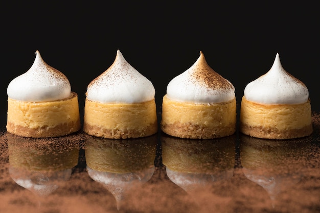 Front view of four desserts with powdered cocoa