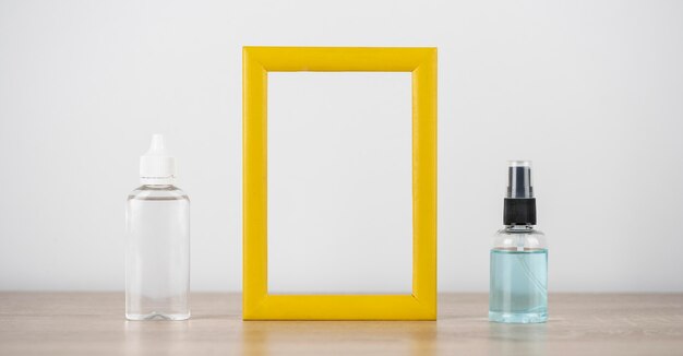 Free Photo front view of frame with hand sanitizer bottles