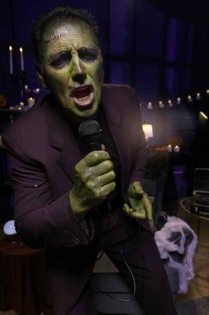 Free Photo front view frankenstein singing indoors